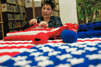 Cecelia Gonzales knits away on a blanket for Arizona Congresswoman Gabrielle Giffords at the Octavia Fellin Library on Wednesday. © 2011 Gallup Independent / Adron Gardner 